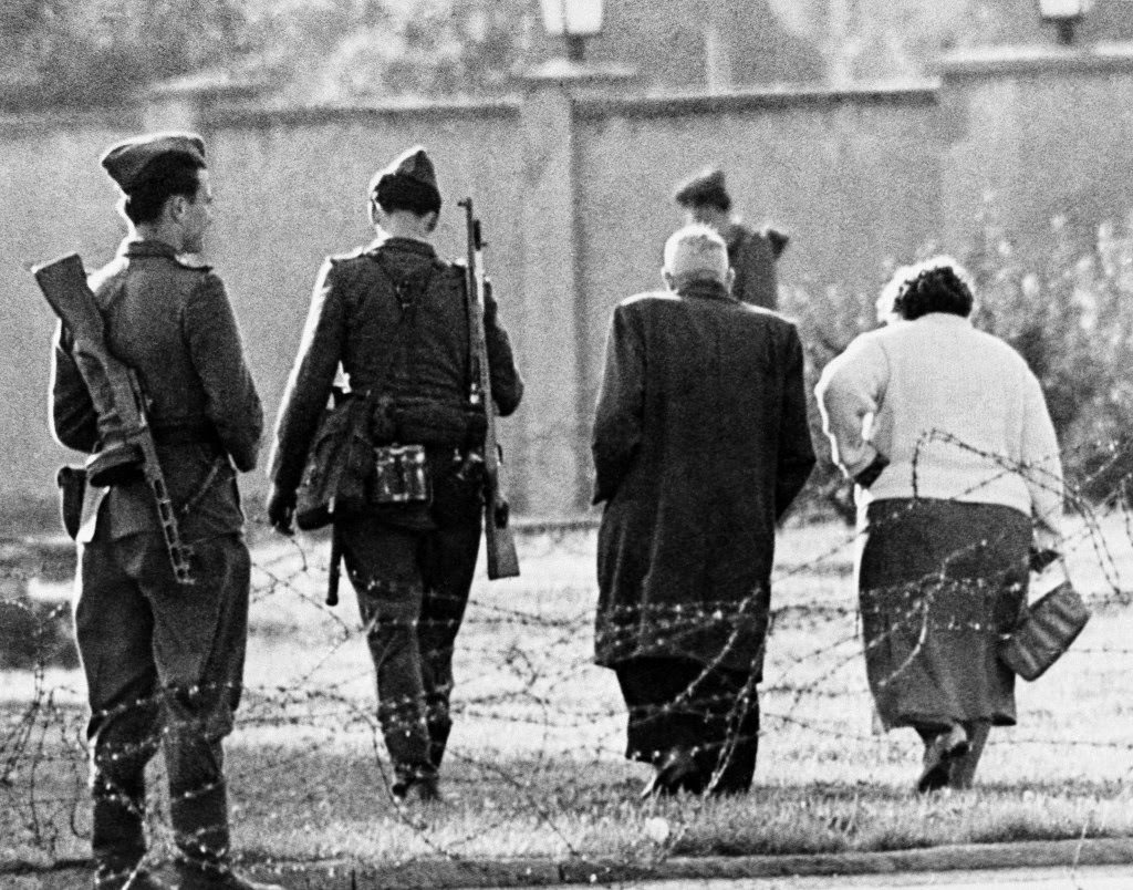 An East German couple is turned away from the border, blocked by East German soldiers and barbed wire, after trying to cross into West Berlin, Aug. 13, 1961.
