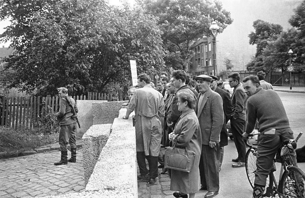 West Berliners at right gather at barrier between east and West Berlin August 18, 1961, watching movements of East German Police.