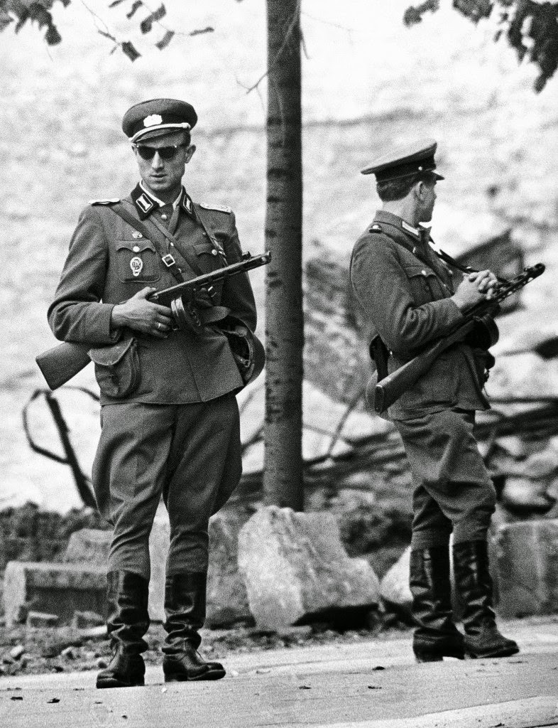 East German National People’s Army soldiers man an unfinished part of the Berlin Wall on August 18, 1961 at the town’s sector division in Berlin, Germany.