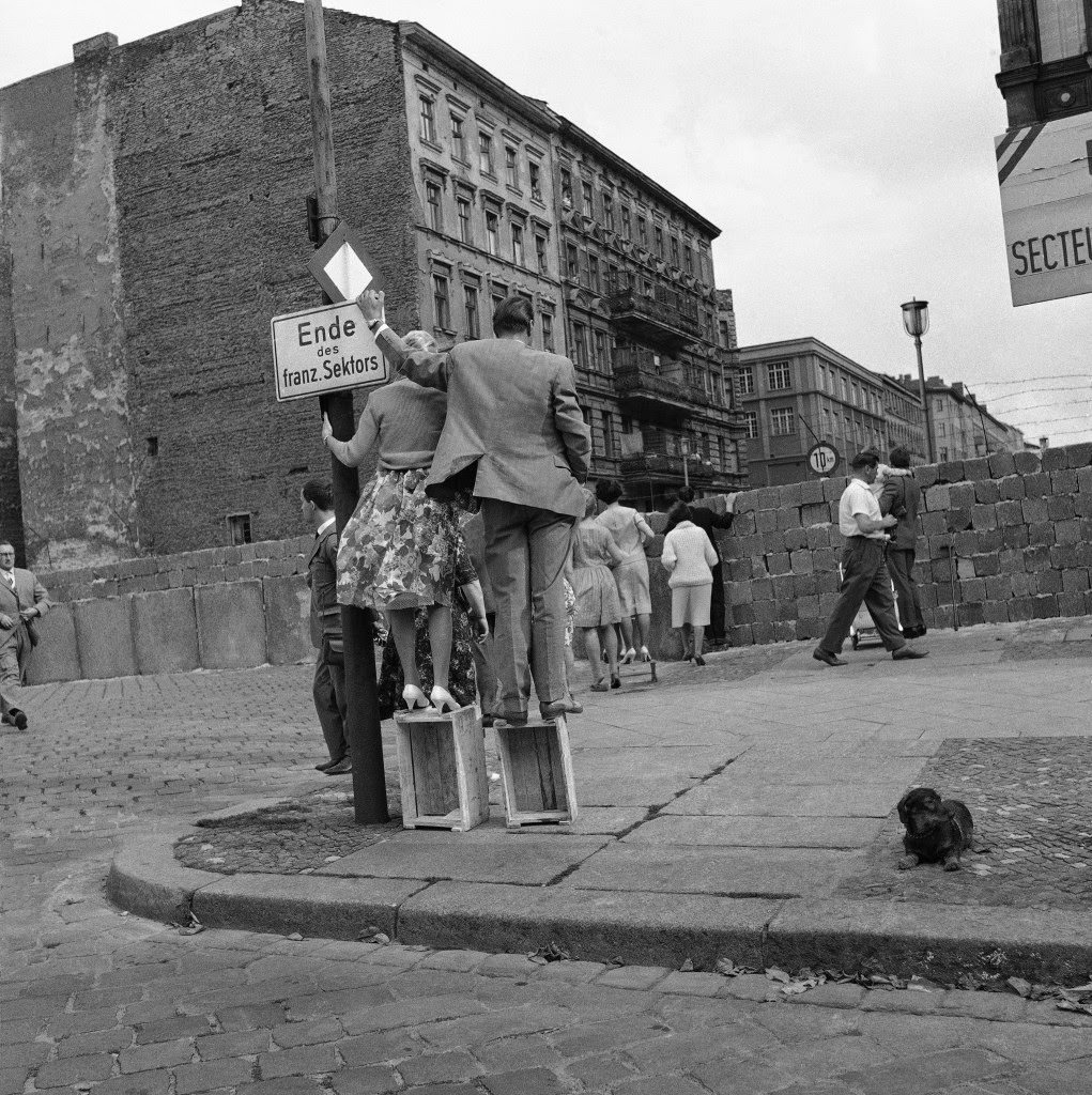 Wooden boxes, used by the couple at left to overcome height of problem in Berlin August 28, 1961.