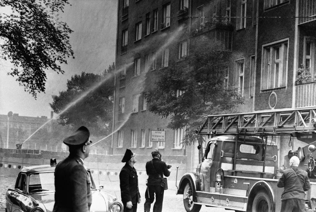 East Berlin Police, behind concrete wall, spray water on area where East Germans escape into West Berlin on Sept. 14, 1961.