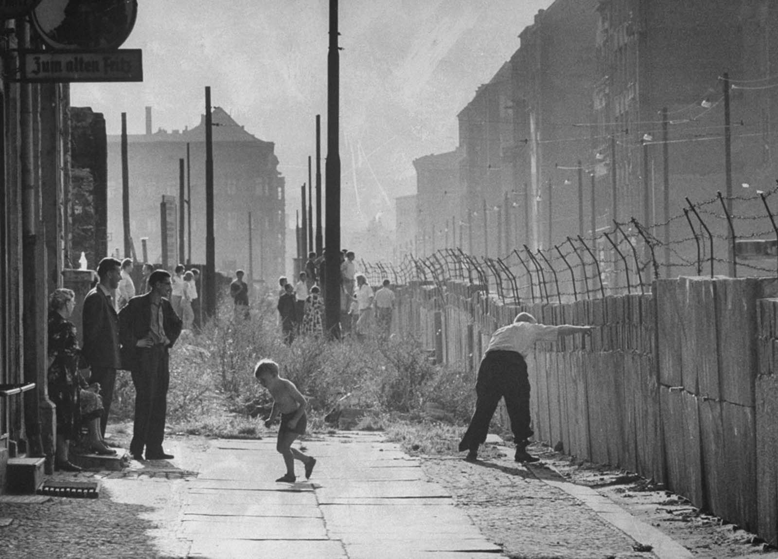 West Berliners gather near the newly built Berlin Wall in August 1961.