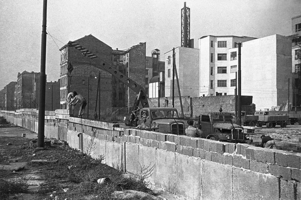 East Berliners use a crane to place concrete glass on wall along border between East and West Berlin Sept. 28, 1961.