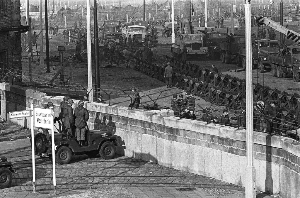 East German workmen guide crane lowering concrete block into position to make wall in front of Brandenburg Gate in East Berlin on Nov. 19, 1961.