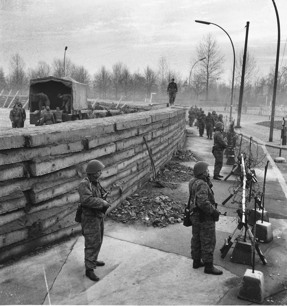 West Berlin police stand guard behind barbed wire along the new 250-yard massive concrete wall at Berlin’s Brandenburg Gate, Germany, on Nov. 23, 1961.