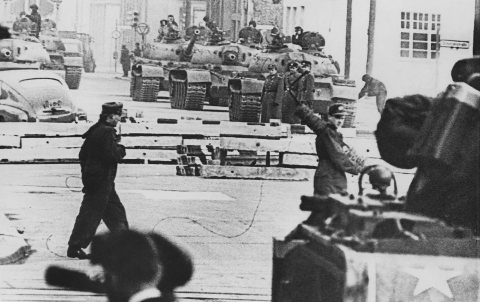 Russian (background) and American (foreground) tanks face each other at the Friedrichstrasse checkpoint in Berlin during the construction of the Berlin Wall on October 28, 1961.