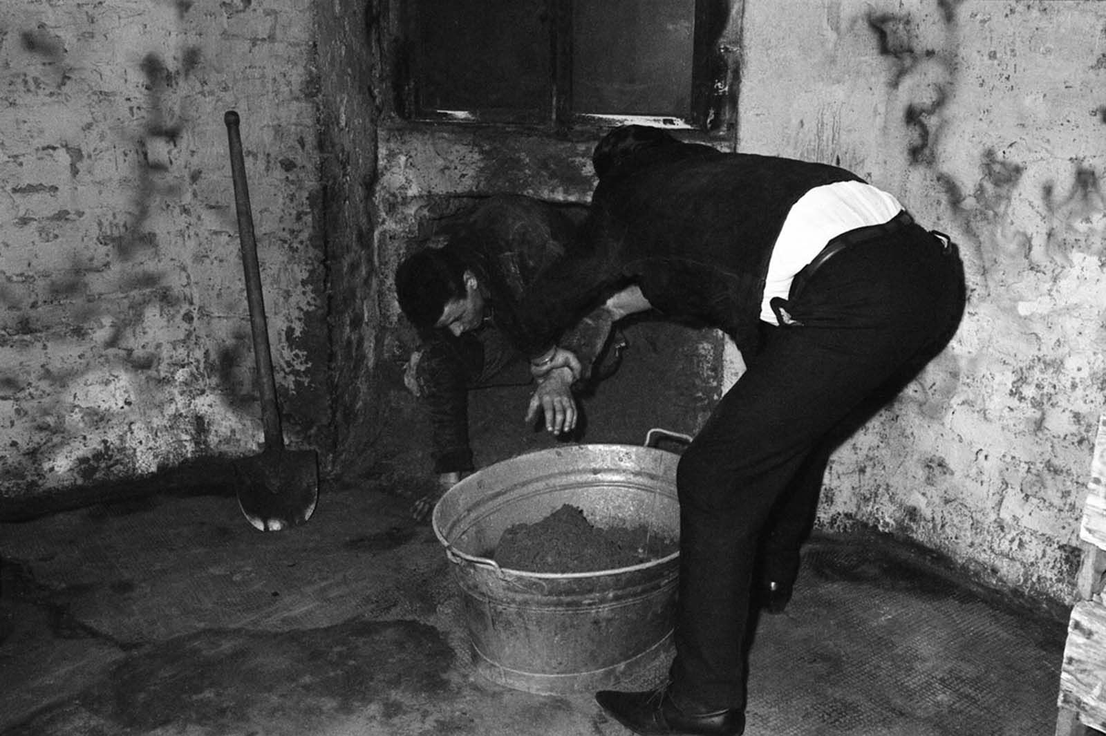 One of six West Berliners who dug a 20-inch-wide tunnel under a border street to East Berlin crawls out sometime over the weekend of June 8–10, 1962.