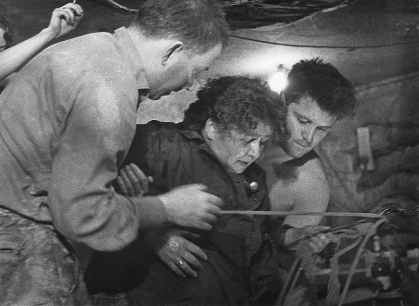 A 75-year-old woman is helped into Tunnel 57, through which 57 East Berlin citizens escaped to the western sector of the city on October 3 and 4, 1964.