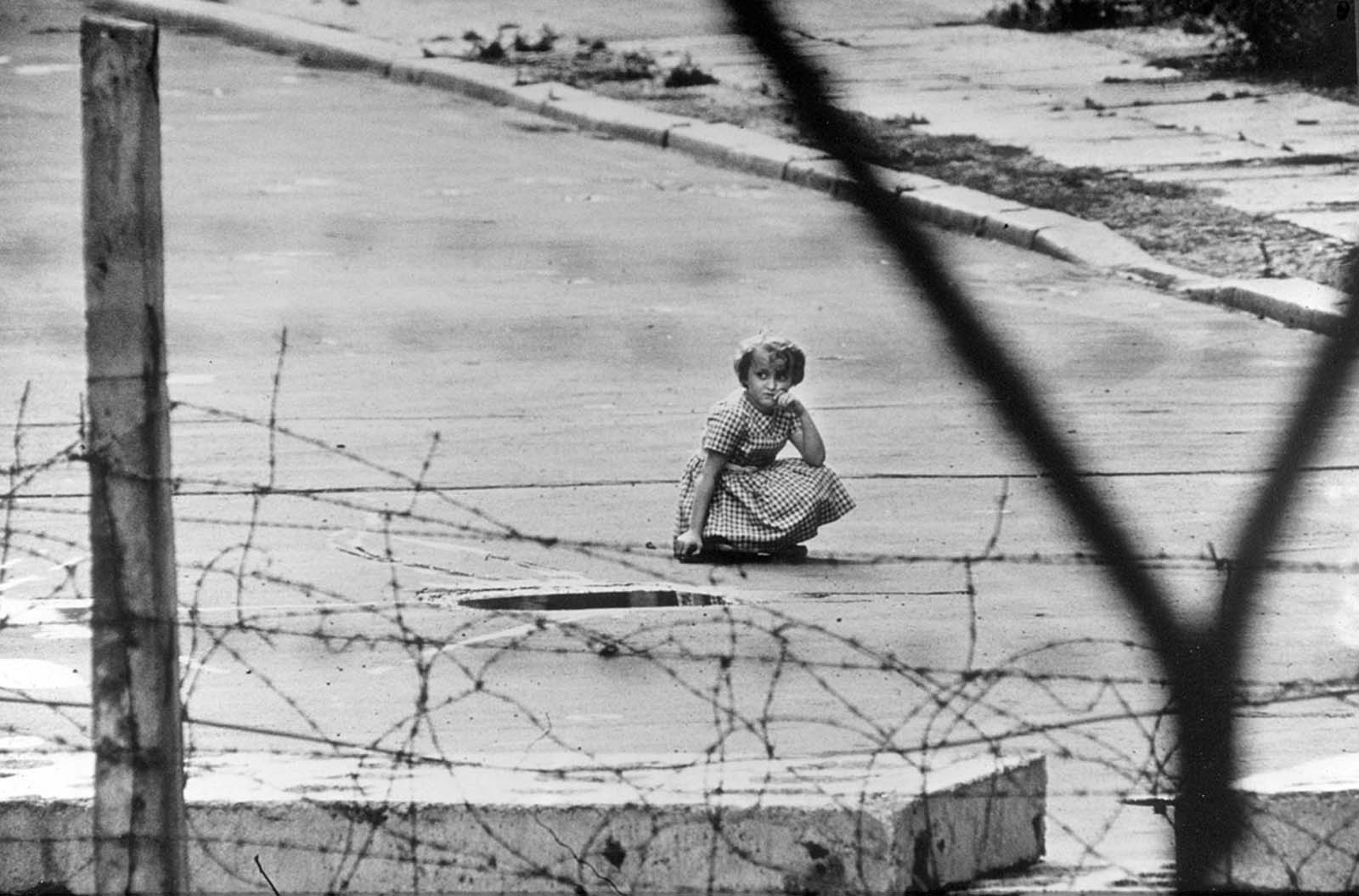 To give the impression of normality, East German authorities sent children to the base of the Berlin Wall to act as if they were at play. Berlin, 1962