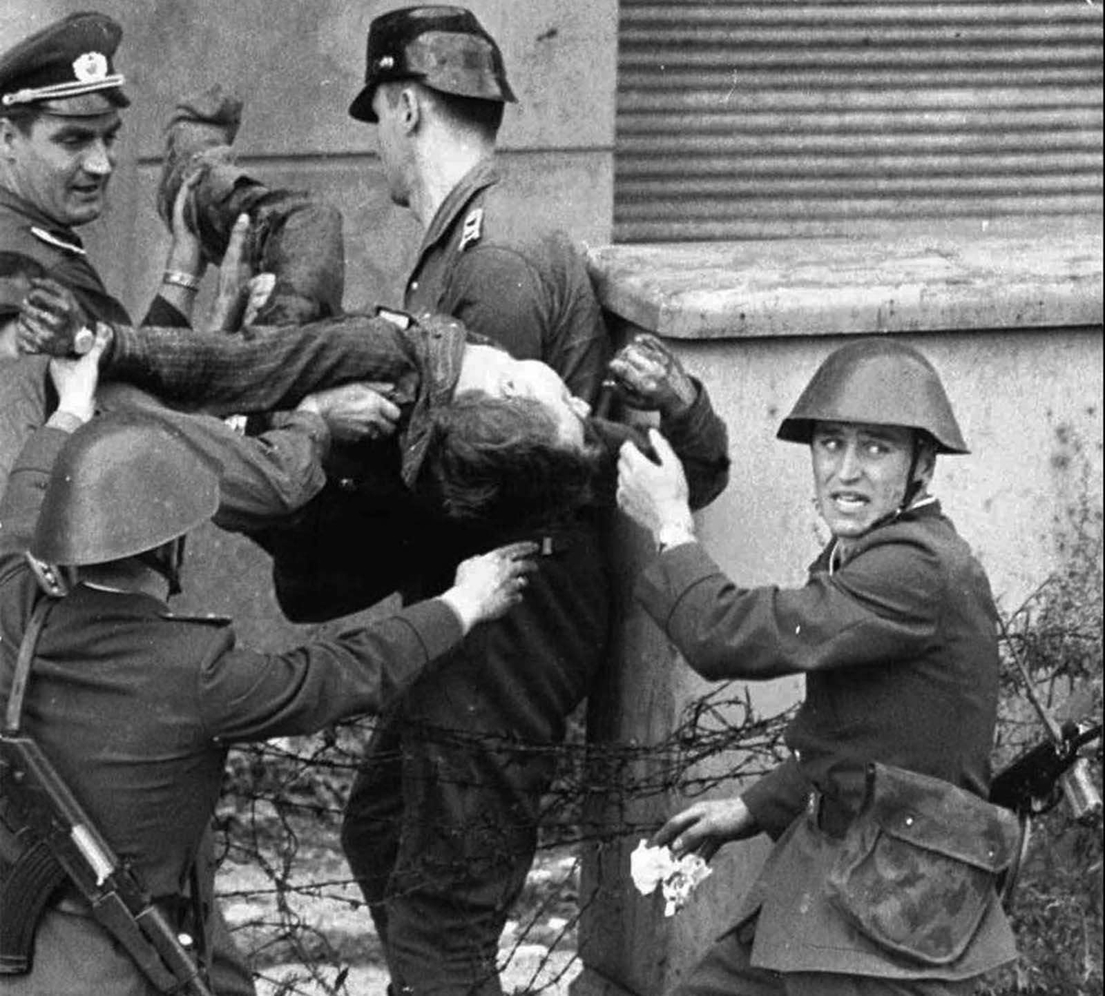 A dying Peter Fechter is carried away by East German border guards who shot him down when he tried to flee to the West in this August 17, 1962