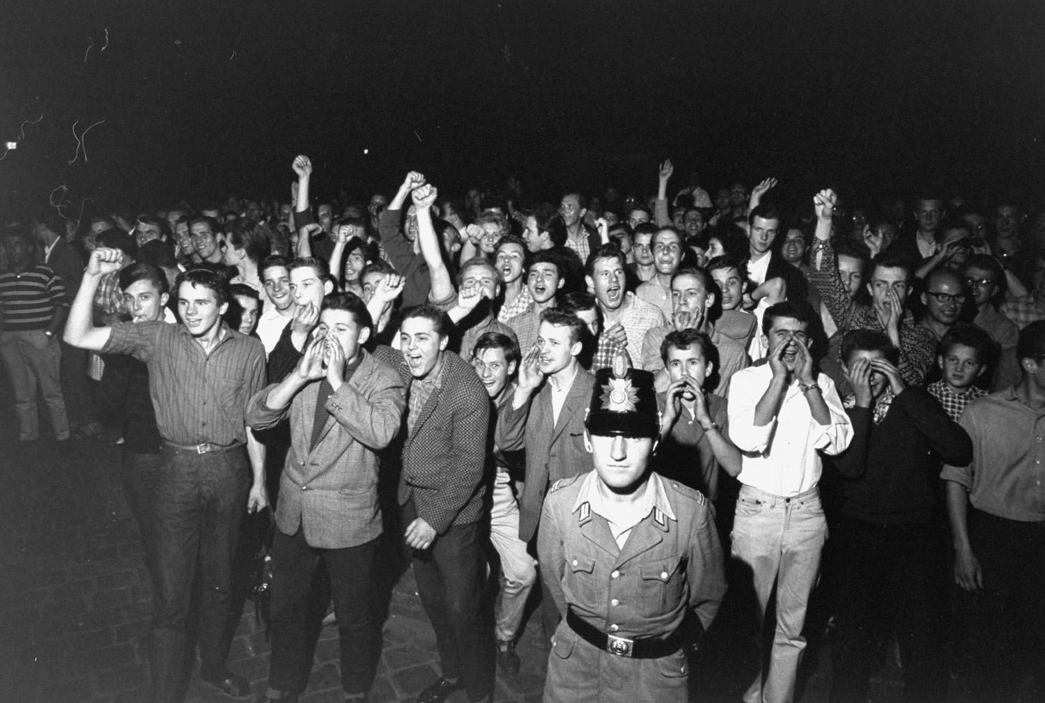 A crowd of West Berlin youths gather to protest the construction of the Berlin Wall in August 1961.