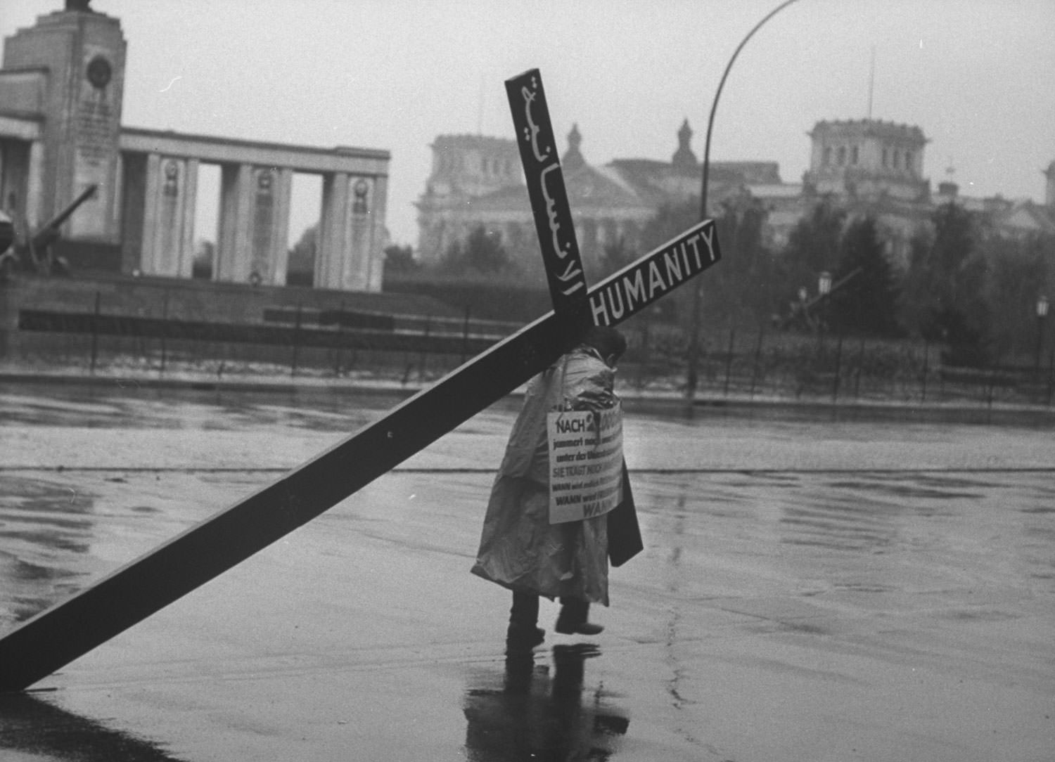A Lebanese businessman, Edmond Khayat, carries an 85-pound wooden cross to protest the Berlin Wall in October 1961.