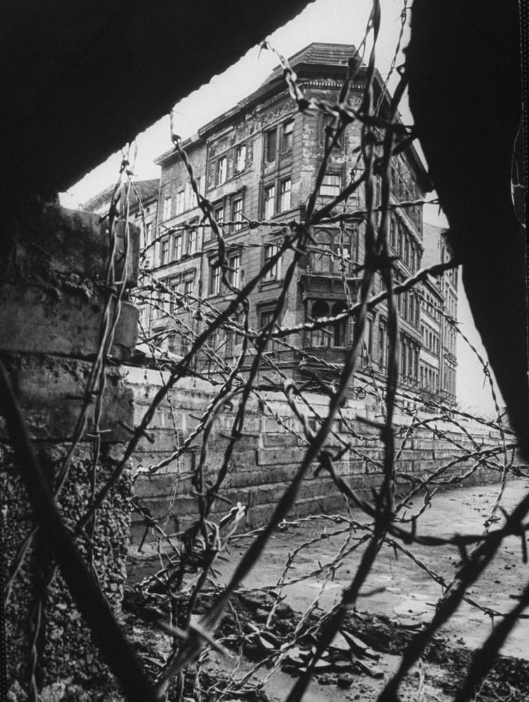 A divided Berlin is seen through barbed wire and rubble in January 1962.