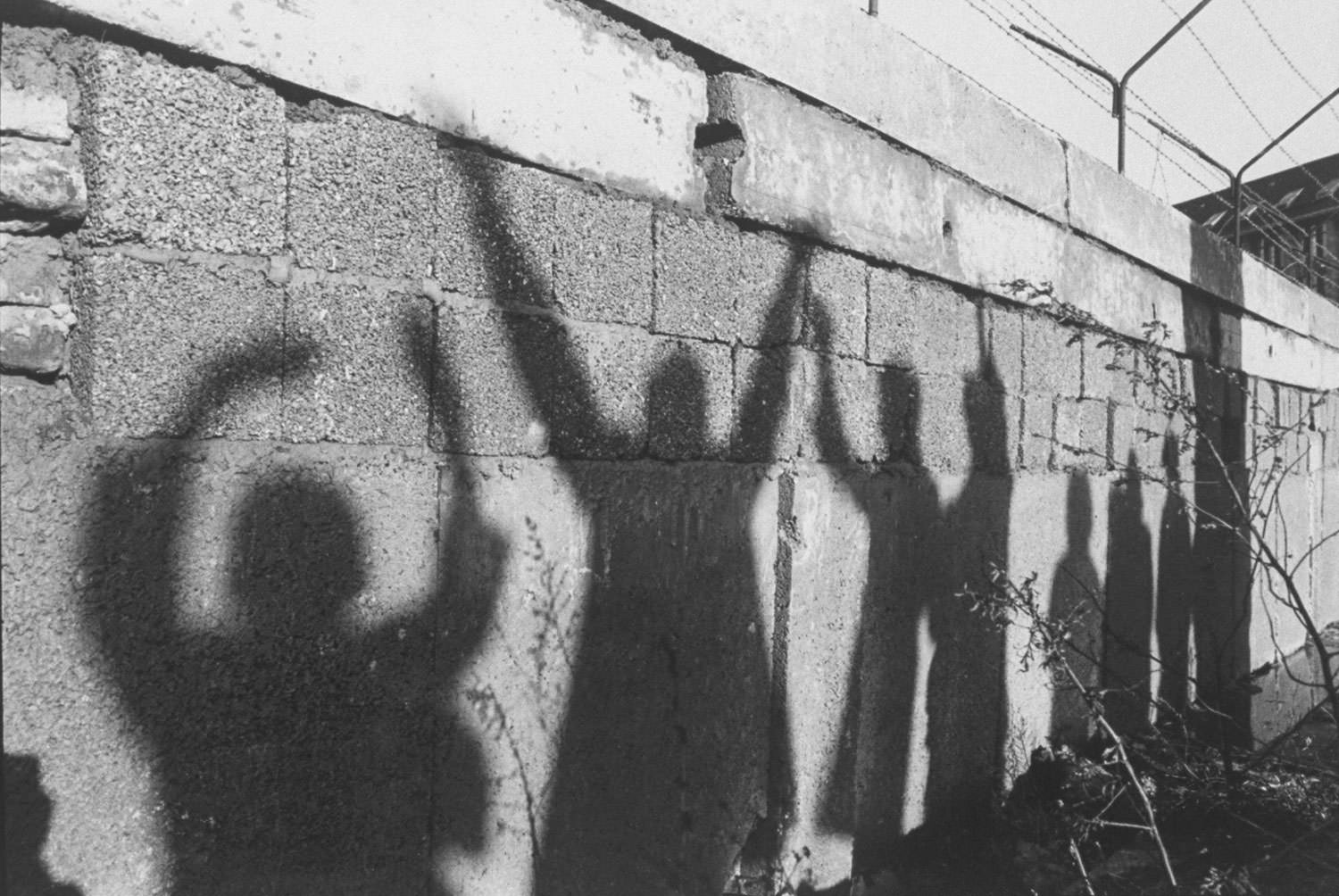 The Berlin Wall bears the shadowy silhouettes of West Berliners waving to their relatives on the unseen, Eastern side of the Wall in December 1962.