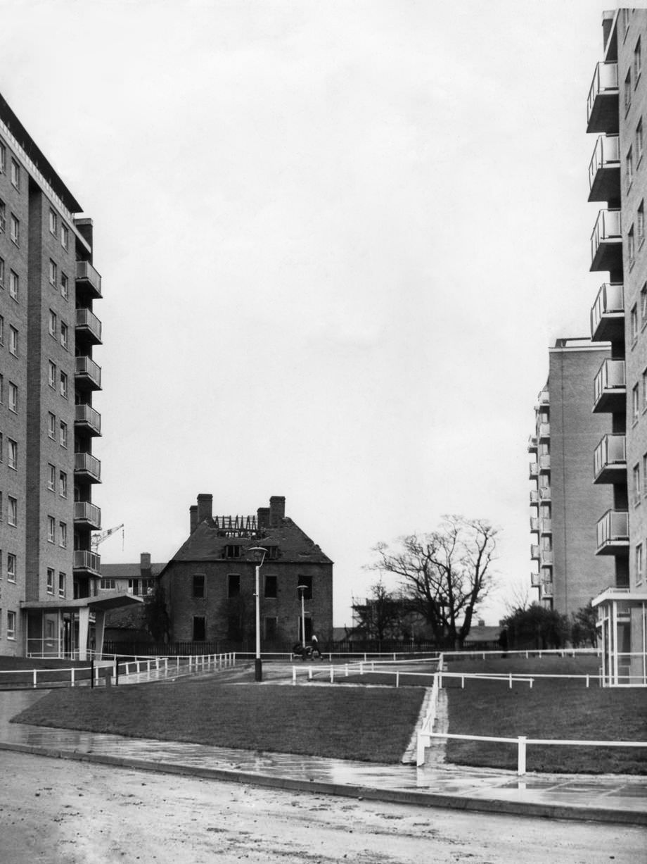 Kingshurst Hall, a 17th century moated hall, now derelict and soon to be demolished, which stands in the shadow of modern flats at Kingshurst Estate, 8th December, 1961.