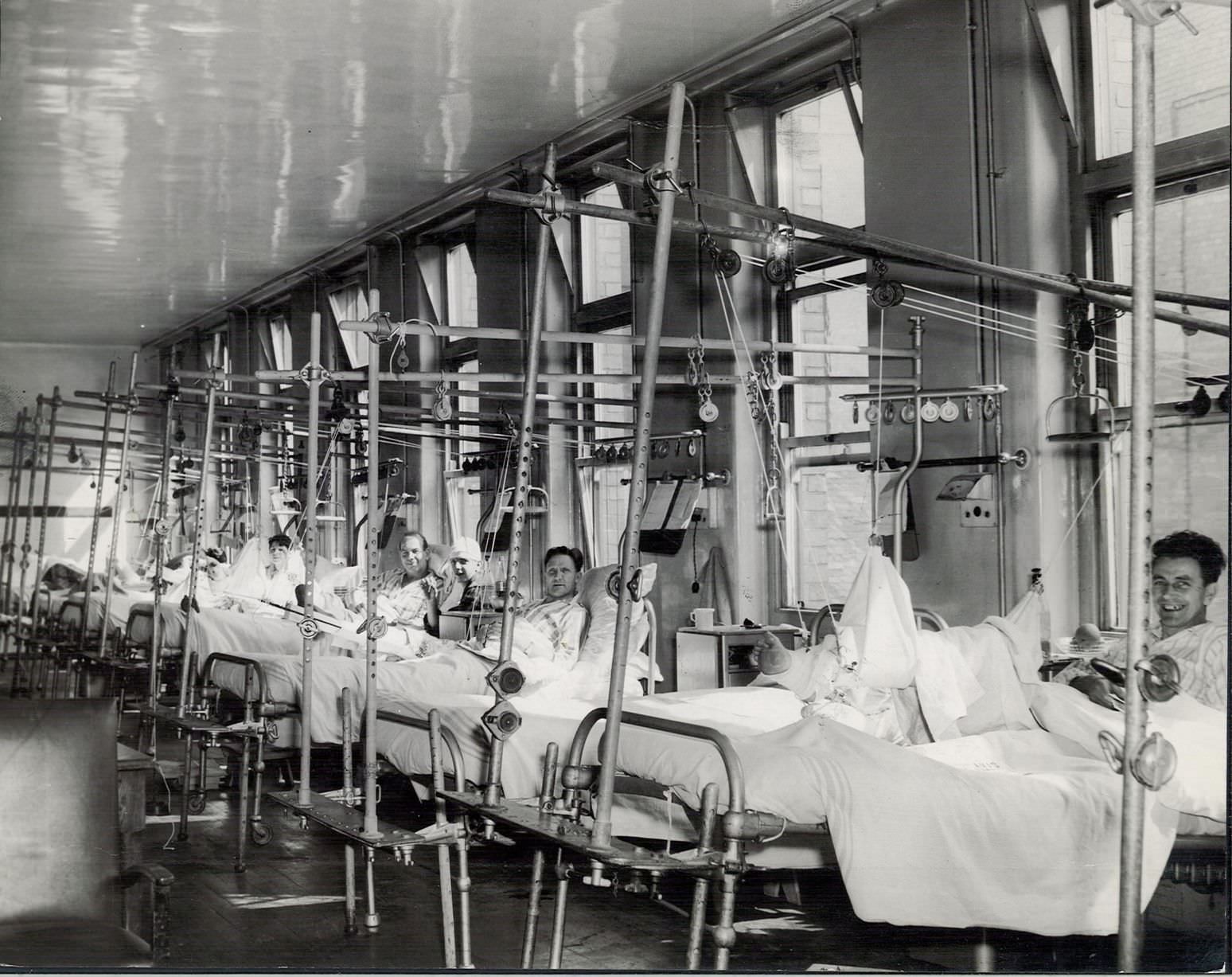 A ward at Birmingham Accident Hospital, the men in beds are all motorcycle cases, in 1960.