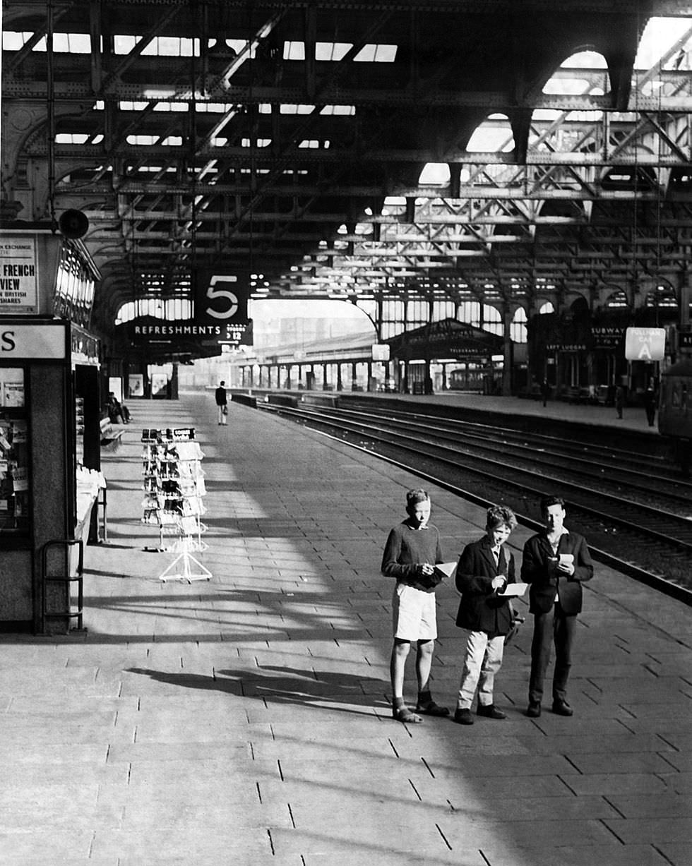 Three young train spotters at a deserted Snow Hill railway station in Birmingham on a bank holiday Monday in 1962.