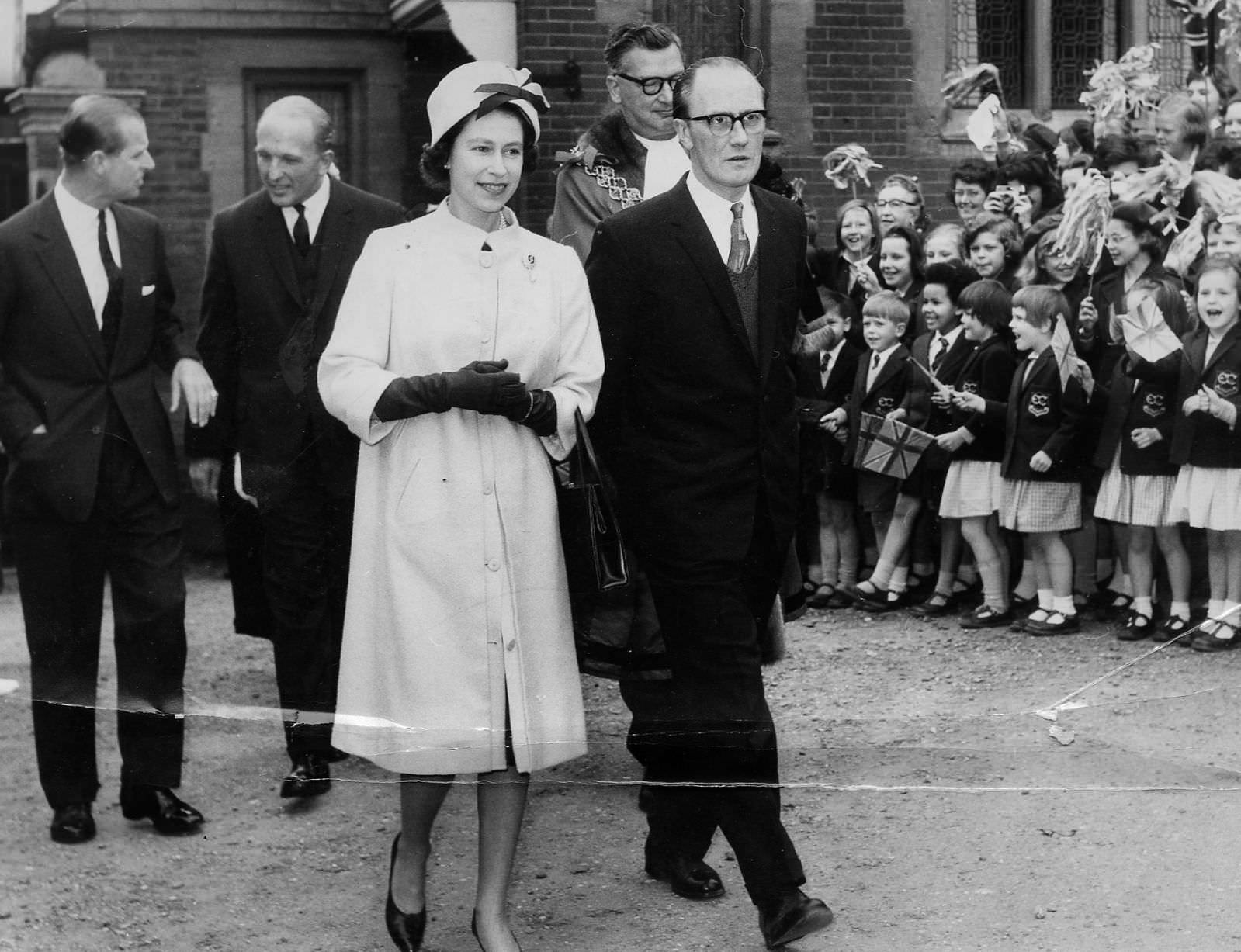 HRH The Queen along with Coun S Turner, Chairman of the Children's Committee, leaving 32 Calthorpe Road in 1963.