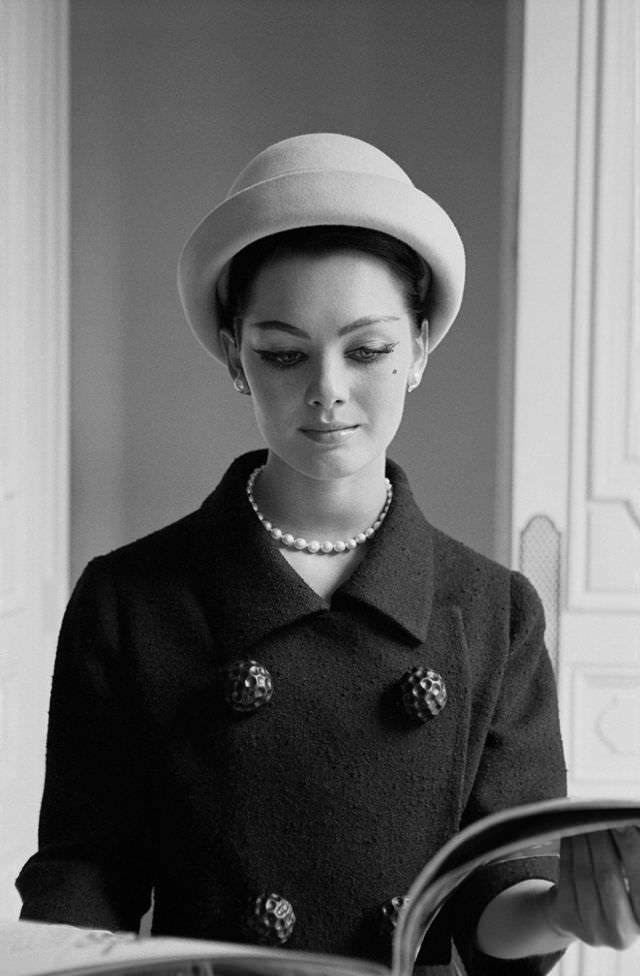 Model in elegant bouclé suit by Givenchy at Givenchy's salon, Paris, June 1960
