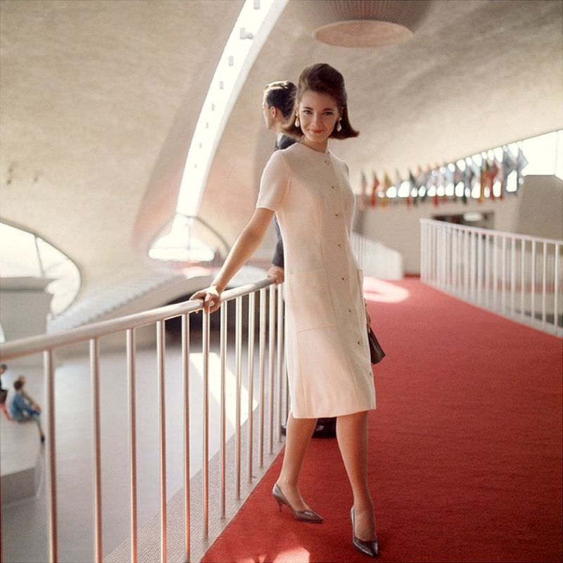 Model in elegant wool dress at the TWA terminal, Idlewild Airport, 1964
