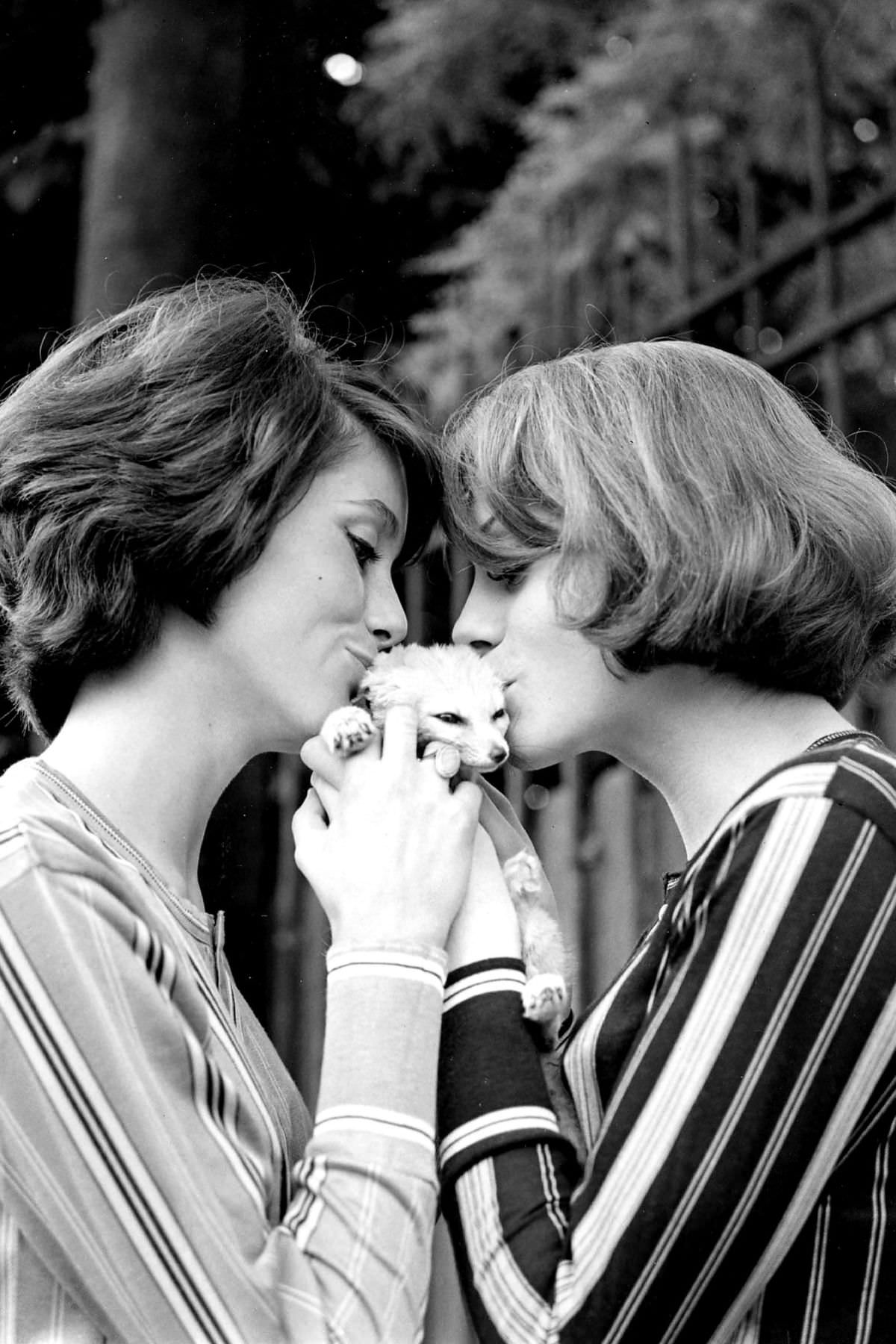 Catherine Deneuve and Françoise Dorléac, in their matching stripes, smothered a feline with kisses in an outdoor portrait series from 1960.