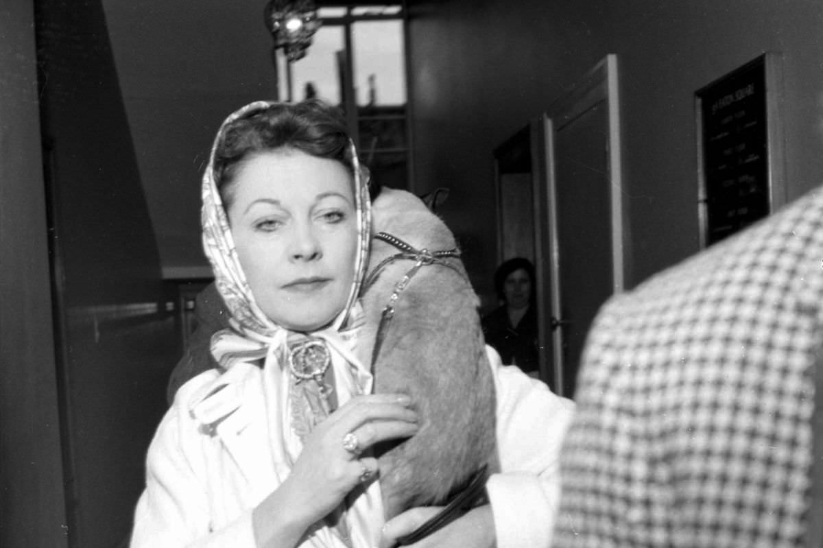 Vivien Leigh, a noted cat lover, carried one over her shoulder in June, 1960.