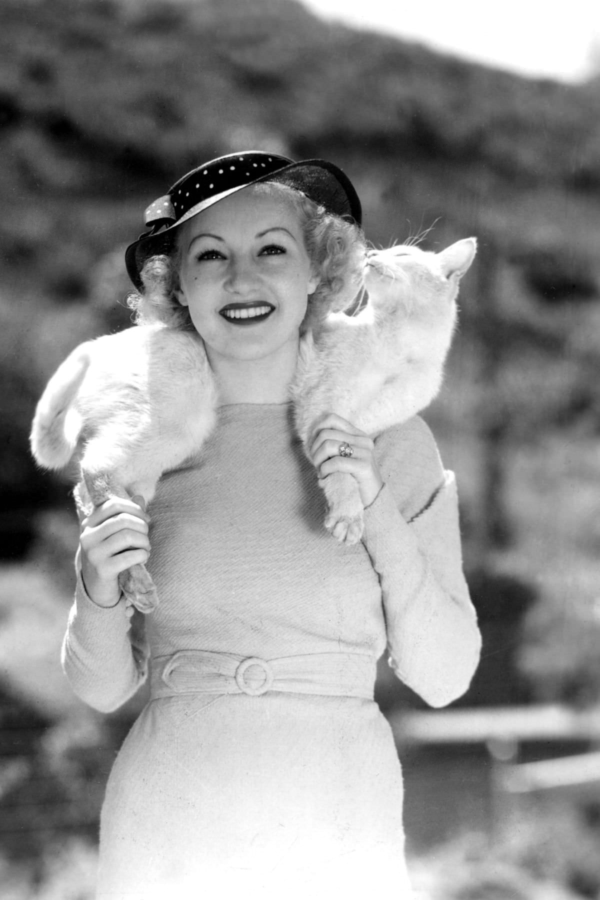 Betty Grable wore her pet cat Whitney around her neck like a fur scarf in 1935. The cat then sniffed her hair.