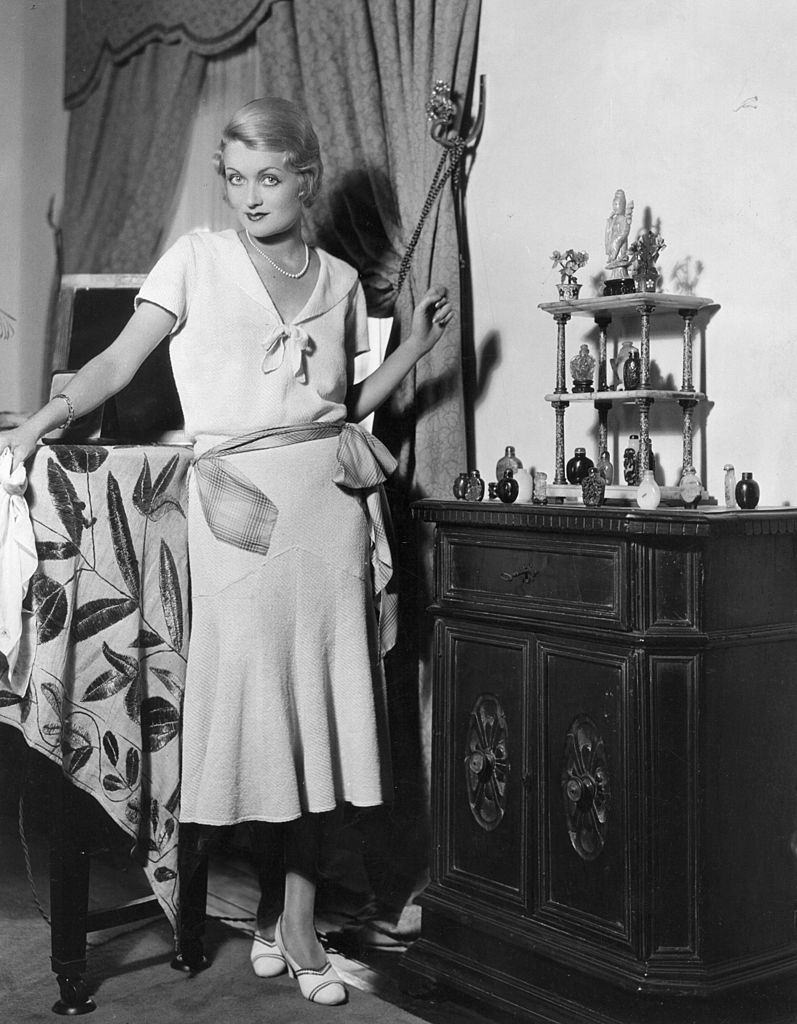 Constance Bennett standing in the corner of her Beverly Hills living room, 1929.