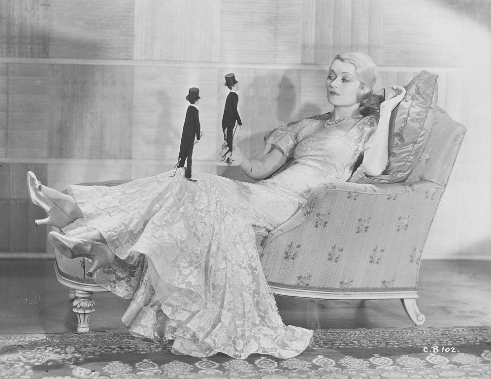 Constance Bennett Holding Doll in a Tuxedo, 1930.
