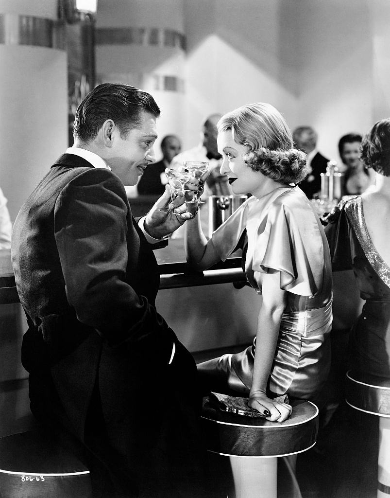 Constance Bennett with Clark Gable toast in a scene from the 1935 film, After Office Hours.
