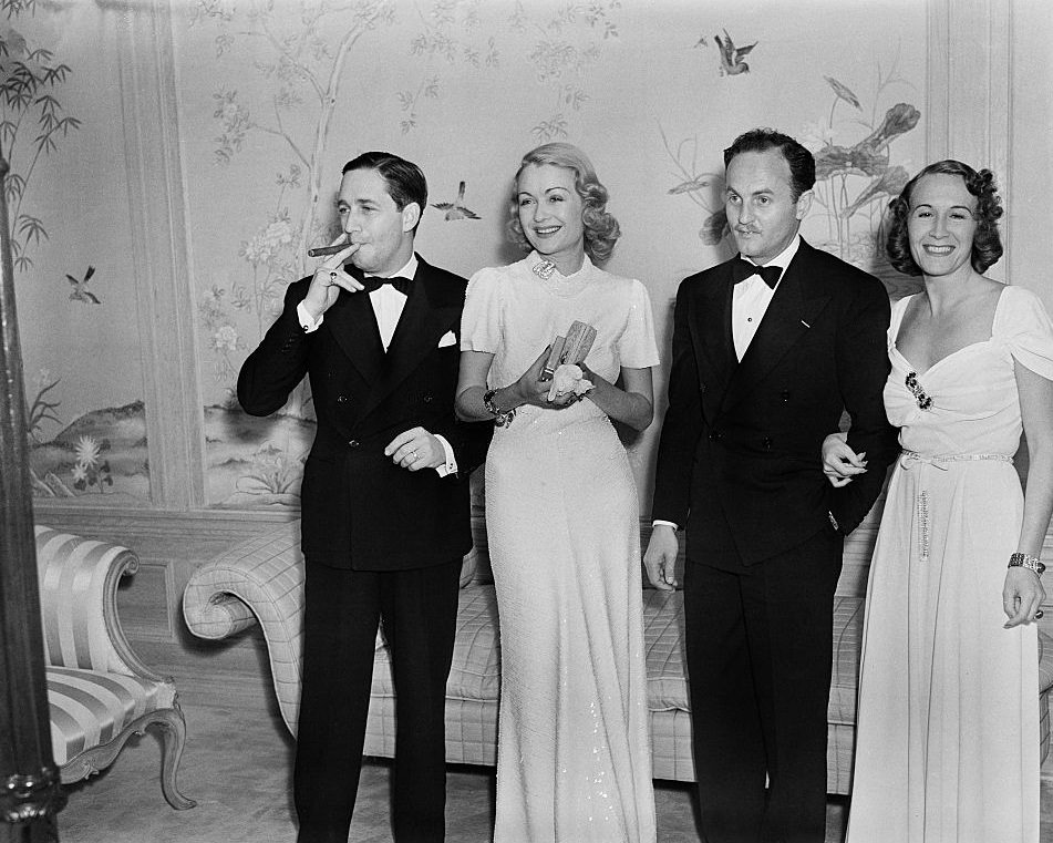 Constance Bennett with Film director Mervyn LeRoy, , Film producer Darryl F. Zanuck and his wife Virginia Fox, 1937.