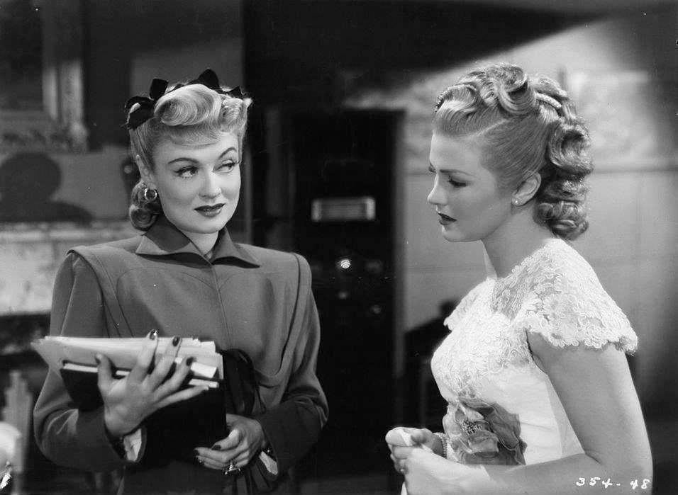 Constance Bennett with Joan Caulfield in a scene from the film 'The Unsuspected', 1947.