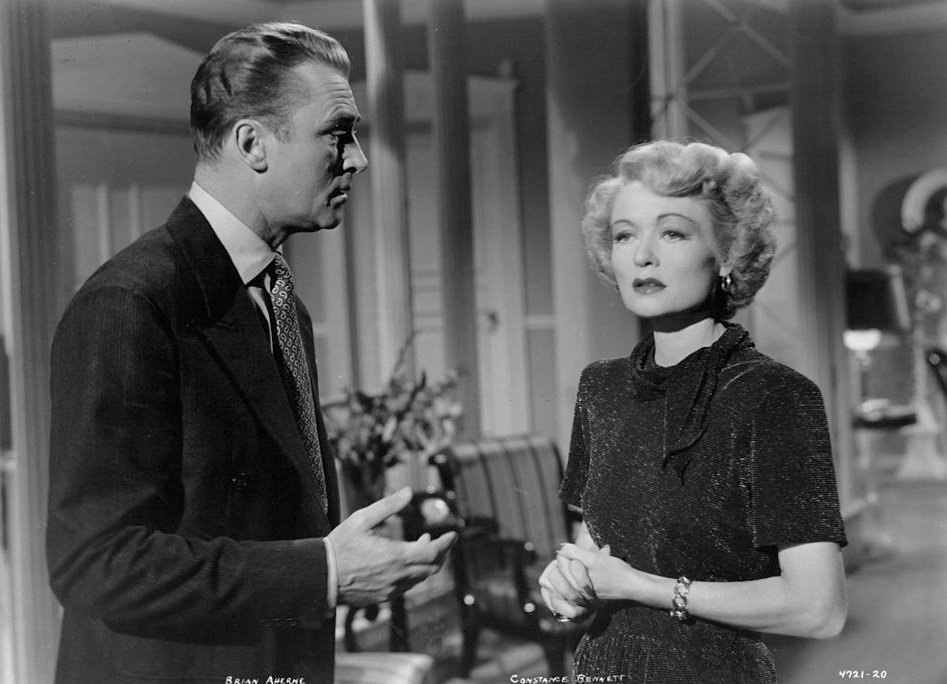 Brian Aherne talking with Constance Bennett in a scene from the film 'Smart Woman', 1948.