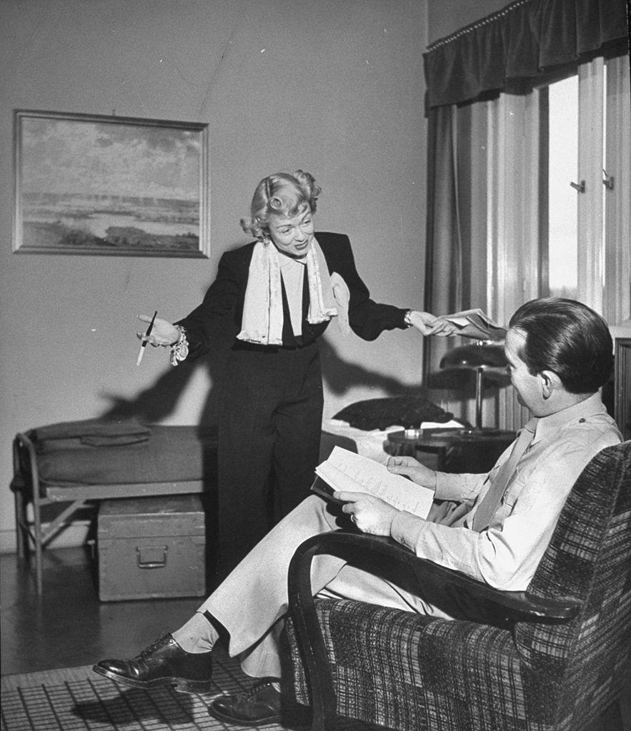 Constance Bennett reading lines with a fellow actor, 1949.