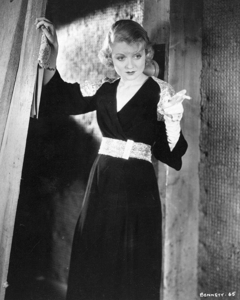 Constance Bennett smoking a cigeratte during a movie scene, 1928.