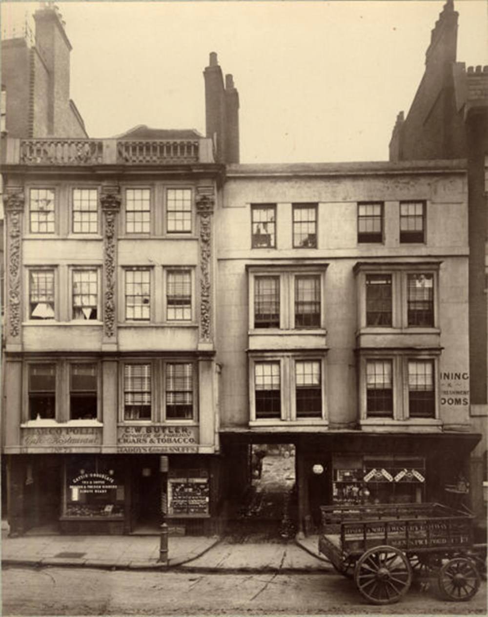 A woman lingers in front of the butcher in Borough High St, Southwark.