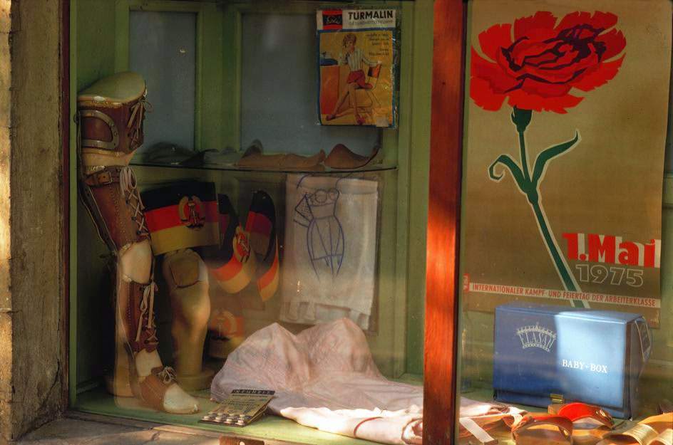 A window of an orthopedic shop with patriotic decorations in Berlin Mitte. East Berlin, 1974.