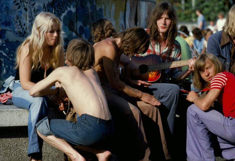 Adolescents sitting at the fountain on Alexanderplatz. East Berlin.