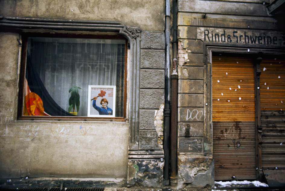 Store window with GDR flag in the district of Prenzlauer Berg. East Berlin, 1974.