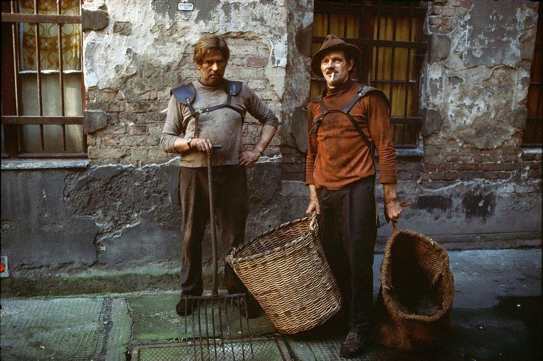 Two men deliver brown coal to apartment blocks in Berlin / Prenzlauer Berg. East Berlin, 1974.