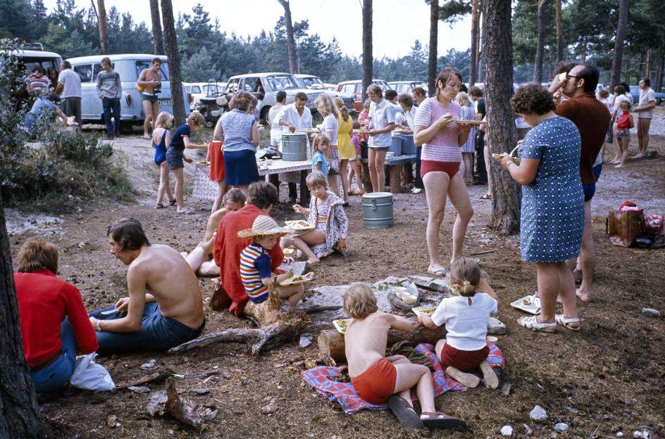 Vacationers having lunch delivered in the woods close to the coast of the Baltic Sea and near the city of Binz, island RŸgen. Binz, GDR, 1974.