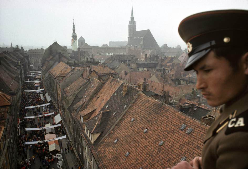 A Soviet soldier takes in the view of the medieval town center from a church tower. Bautzen.