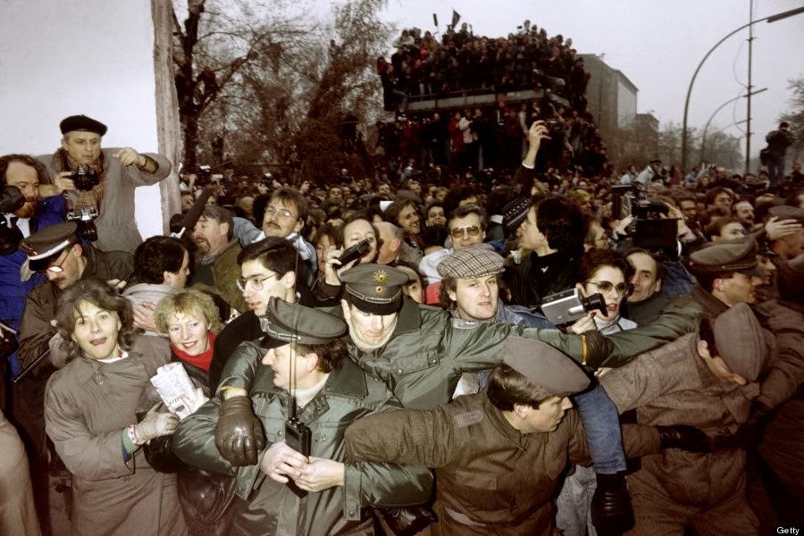 East and West German Police contain the crowd of East Berliners flowing through the recent opening made in the Berlin wall at Potsdamer Square, on November 12, 1989.