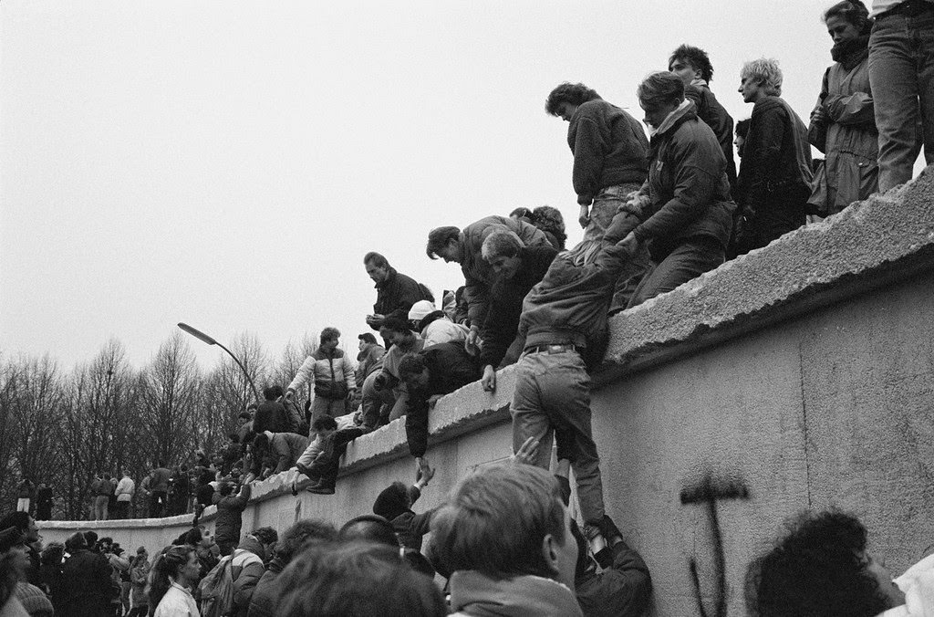 East Berliners climb onto the Berlin Wall to celebrate the effective end of the city's partition, 31st December 1989.