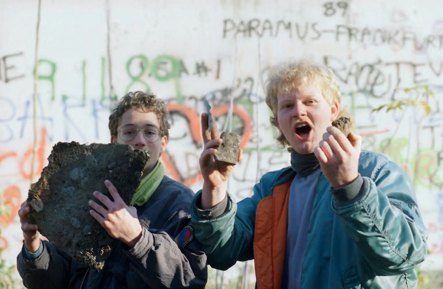 A man hammersTwo men proudly show off bricks of the Berlin Wall they found near Brandenburg Gate in Berlin after the opening of the East German border to the West. Nov. 10, 1989 away at Checkpoint Charlie June 2, 1990.
