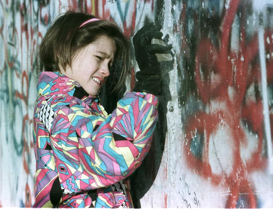 A young West German girl hammers the Berlin Wall November 19.