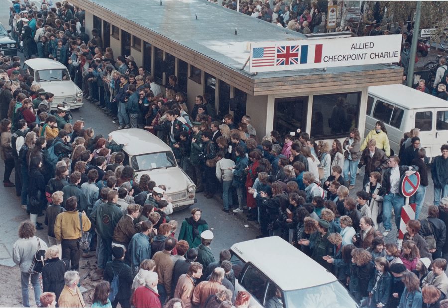 Two men from West and East Germany meet again and embrace each other after the arrival of a special train from Magdeburg at Helmstedt railway station.