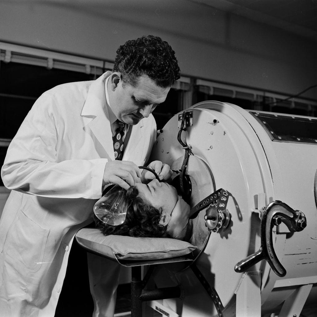 Medical staff attending a polio patient in an iron lung at a Polio Center in Houston, Texas, 1954.