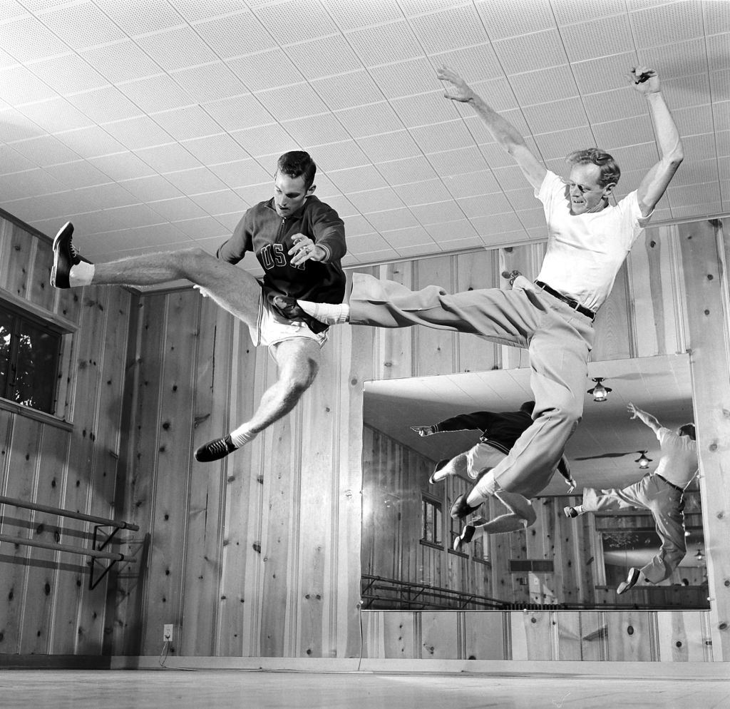 Walt Davis with a man jumping on a ballet school, Houston, 1956.