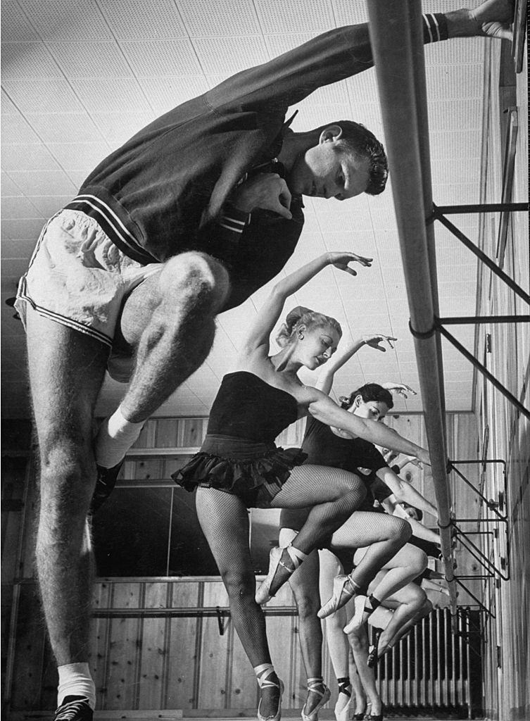 Walter Davis doing ballet exercises in class of women dancers, 1952.